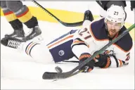  ?? John Locher / Associated Press ?? Oilers defenseman Mike Green (27) fights for the puck against the Vegas Golden Knights. Green has opted out of playing the remainder of this season.