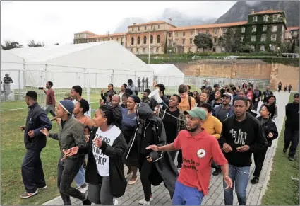  ?? Picture: David Ritchie/ANA ?? NOT CONDUCIVE: Protesting workers pass the tented exam venues at UCT on their way to hand over a memorandum to Vice-Chancellor Max Price.The university has erected the large tents on its rugby fields for students to write their year-end exams without...