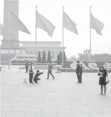  ?? AGENCE FRANCE PRESSE ?? Chinese tourists pose in Tiananmen Square, while the Communist Party hold its 19th Congress in Beijing on October 21.