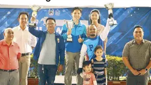  ??  ?? What A Feeling owner Allan Keith Castro (fourth from left), jockey Mark A. Alvarez (fifth from left) and trainer Wally Manalo (third from left) hoist their trophies after What A Feeling’s rousing win at the San Lazaro Leisure Park in Carmona, Cavite. They are joined by Philracom executive director Andrew Rovie Buencamino (right), Manila Jockey Club manager Jose Magboo (left), his deputy J-fel Cuevas and Lucky Lea Forbes.