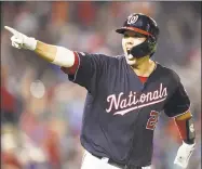  ?? Mitchell Layton / Getty Images ?? The Nationals’ Kurt Suzuki celebrates a walkoff threerun home run in the ninth inning against the Mets on Tuesday night in Washington.