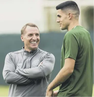  ??  ?? 0 Celtic manager Brendan Rodgers chats with Australian World Cup player Tom Rogic at training.