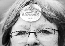  ?? JUSTIN TANG THE CANADIAN PRESS ?? Shirley Taylor wears a "Burnt by Phoenix" sticker on her forehead during a rally against the Phoenix payroll system in February.