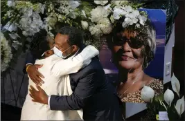  ?? PHOTOS BY PATRICK SEMANSKY — THE ASSOCIATED PRESS ?? A mourner embraces Angela Crawley, left, daughter of Ruth Whitfield, a victim of the Buffalo supermarke­t shooting, before a memorial service in Buffalo, N.Y.