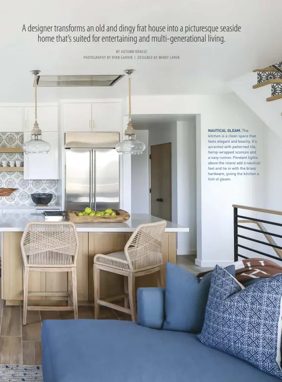  ??  ?? NAUTICAL GLEAM. The kitchen is a clean space that feels elegant and beachy. It’s accented with patterned tile, hemp-wrapped sconces and a navy runner. Pendant lights above the island add a nautical feel and tie in with the brass hardware, giving the kitchen a hint of gleam.