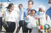  ?? ( Flash90) ?? ALIYAH MINISTER Pnina Tamano- Shata and Jewish Agency Chairman Isaac Herzog welcome 100 new immigrants from the Falash Mura community at Ben- Gurion Airport, on May 21.