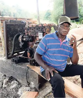  ?? IAN ALLEN ?? Lambert Brown sits at his truck engine-powered sawmill in St Elizabeth.