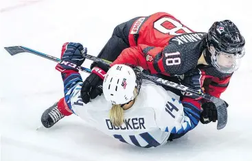  ?? — THE CANADIAN PRESS FILES ?? Canada’s Halli Krzyzaniak knocks down Brianna Decker of the U.S. during Four Nations Cup preliminar­y play in Saskatoon on Wednesday.
