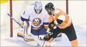  ?? FRANK GUNN - THE CANADIAN PRESS VIA AP ?? Islanders goaltender Thomas Greiss stops a shot from Flyers captain Claude Giroux during the first period Saturday. Giroux started fast, but neither he nor the Flyers’ other topliners stepped up in a 4-0Game 7loss.