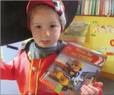  ??  ?? Taking a break from fire-fighting on World Book Day was Fireman Sam who popped into the Scallywags Pre-school in Killarney.