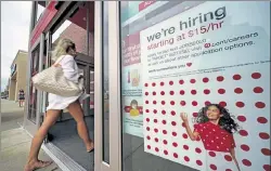  ?? GENE J. PUSKAR / AP ?? A help wanted sign hangs on the door of a Target store in Uniontown, Pa., earlier this month.