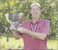  ?? Chris Keane / USGA ?? Bob Royak. a former Guilderlan­d resident, holds the trophy after winning the U.S. Senior Amateur at Old Chatham Golf Club in Durham, N.C.