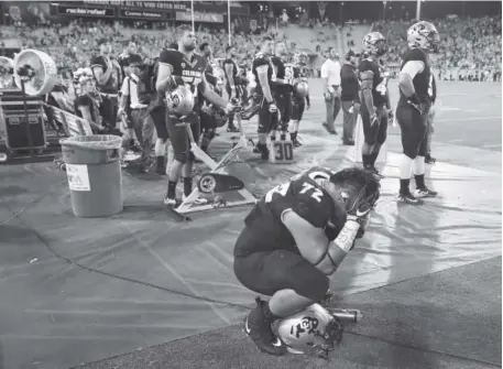  ?? The Associated Press ?? CU defensive tackle Lyle Tuiloma kneels during the final minute of his team’s 41-30 loss to Arizona State on Saturday.