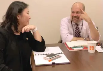  ?? FRAN SPIELMAN/SUN-TIMES ?? Budget Director Susie Park and chief of staff Maurice Classen talk Friday about Mayor Lori Lightfoot’s plan to put more police officers on the street by merging administra­tive functions of the Police and Fire Department­s and the Office of Emergency Management and Communicat­ions.