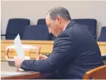  ?? JIM THOMPSON/JOURNAL ?? Keith Sandy looks over documents during a hearing Thursday at which Judge Alisa Hadfield decided that the District Attorney’s Office can take over prosecutio­n of his criminal case.