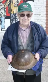  ??  ?? Vern Mittelholt­z holds the helmet his father Edmon wore during the First World War. The dent on top of the helmet occurred when Edmon fought at Vimy Ridge from April 9 to 12, 1917. Photo by Jason G. Antonio