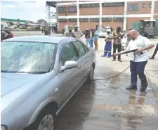  ?? ?? Deputy Minister of Industry and Commerce and Member of Parliament for Bulawayo South Constituen­cy, Cde Raj Modi, washing a car during a fundraisin­g event organised by the Forever Associates of Zimbabwe (FAZ) Bulawayo South Constituen­cy chapter in Bellevue yesterday