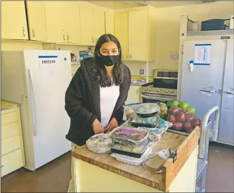  ?? (Courtesy Photo/Rachna Jawa) ?? Vedika Jawa poses with freshly baked desserts inside South Hayward Parish in Fremont, Calif. Jawa, a high school junior, distribute­s sweets to 15 shelters through a nonprofit group she started when she was 13.