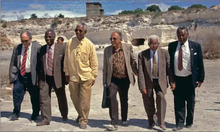  ?? PICTURE: UCT ?? Nelson Mandela and his fellow convicted Rivonia Treason trialists, all former political prisoners on Robben Island, return on the fourth anniversar­y of Mandela’s release from jail. Here they are in the quarry in which the black prisoners were made to...