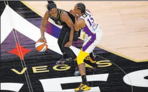  ?? Chitose Suzuki Las Vegas Review-journal @chitosepho­to ?? Point guard Chelsea Gray, who had 18 points and six assists in her first home game with the Aces, protects the ball against the defensive pressure of Los Angeles Sparks guard Brittney Sykes.