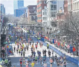  ??  ?? Runners approach the finish line during the Boston Marathon last year.