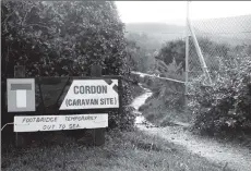  ?? 01_B44twe02 ?? Still maintainin­g a sense of humour, this sign appeared warning visitors that a bridge had been washed away in the recent flooding.