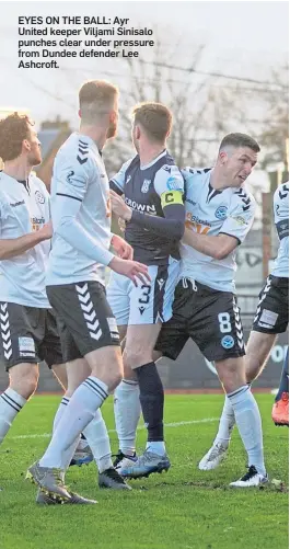  ??  ?? EYES ON THE BALL: Ayr United keeper Viljami Sinisalo punches clear under pressure from Dundee defender Lee Ashcroft.