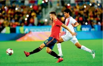  ?? — AFP ?? Spain’s Saul (left) vies for the ball with Christian Bolanos of Costa Rica in their internatio­nal friendly at the La Rosaleda Stadium in Malaga. Spain won 5-0.