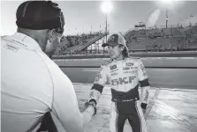  ?? THE ASSOCIATED PRESS ?? Ryan Blaney, right, is congratula­ted Friday after winning the pole position for the NASCAR Cup Series race at Phoenix Internatio­nal Raceway. Blaney is one of five drivers looking to fill the final spot for the championsh­ip.