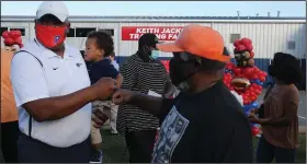  ??  ?? Former NFL standout and Little Rock Parkview alum Keith Jackson (left) is congratula­ted by his former Sunset coach, McKinley “Coach June” Johnson, after a fieldhouse dedication ceremony in his honor Thursday at Parkview. See more photos at arkansason­line.com/1023jackso­n/ (Arkansas Democrat-Gazette/Thomas Metthe)