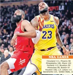  ??  ?? Los Angeles Lakers’ LeBron James, right, vies for position under the basket next to Houston Rockets’ James Harden during the first half Thursday in Los Angeles. (AP)