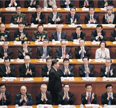  ?? CHRISTOPHE PETIT TESSON / POOL VIA AP ?? Lawmakers applaud President Xi Jinping, centre, after he delivered a 38-minute address in Beijing on Tuesday.