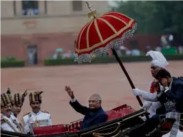  ??  ?? President Ram Nath Kovind waves as he arrives in a traditiona­l horse-driven carriage at Rashtrapat­i Bhavan after being sworn in last month in New Delhi —