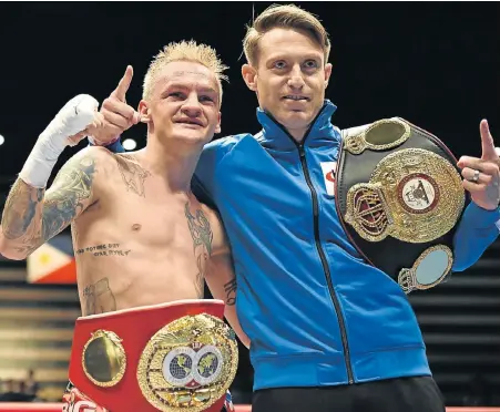  ?? Picture: AFP/ KAZUHIRO NOGI ?? HISTORIC WIN: South Africa’s Hekkie Budler and his trainer Colin Nathan celebrate victory over Japan’s Ryoichi Taguchi in Tokyo yesterday