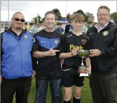  ??  ?? Zach Cullen accepts the cup from Martin O’Connor, General Manager of BrayWander­ers, and Brian Kavanagh, fixtures secretaryW­DSL, and Peter Porter, Chairman of the WDSL.