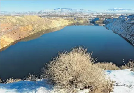  ?? MARILYN NEWTON/AP ?? Water partially fills a huge pit left over from mining operations on the Yerington Paiute reservatio­n in Yerington, Nev., in 2013 photo.