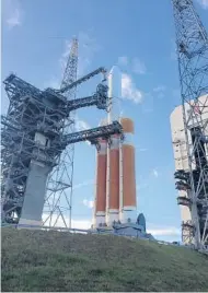  ?? RED HUBER/STAFF PHOTOGRAPH­ER OrlandoSen­tinel.com ?? The Parker Solar Probe sits atop heavy-lifting Delta 4 rockets Friday evening. The launch window was to open after the Sentinel was printed this morning. To learn the latest about the mission, go to