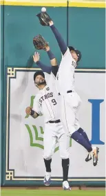  ?? ERIC CHRISTIAN SMITH/THE ASSOCIATED PRESS ?? The Astros’ George Springer catches a fly ball hit by the Yankees’ Greg Bird in front of Marwin Gonzalez on Saturday in Game 7 of the ALCS in Houston.