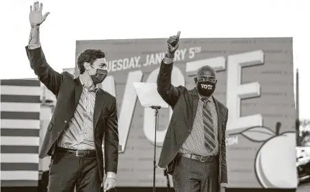  ?? Doug Mills / New York Times ?? Democrats Jon Ossoff, left, and the Rev. RaphaelWar­nock salute supporters after a pre-runoff campaign event in Atlanta.