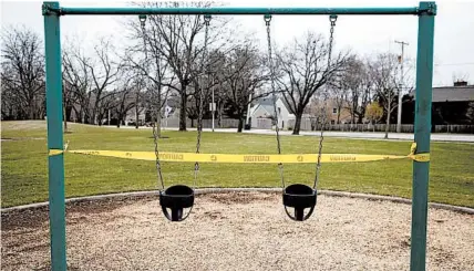  ?? ERIN HOOLEY/CHICAGO TRIBUNE ?? The playground at Lovelace Park in Evanston, Illinois, is taped off March 31.