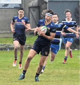  ?? PHOTO: LINDA ROBERTSON ?? Dunedin fullback Tommy Clout cherishes possession during his team’s Dunedin premier club rugby match against Kaikorai at Kettle Park last Saturday.