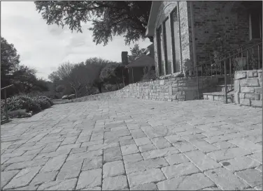  ?? Benny Snyder/AP ?? Paving: This photo shows a stone pavers driveway in a residentia­l neighborho­od in Dallas, Texas. One driveway at a time, many homeowners and communitie­s are opting for permeable paving options instead of traditiona­l asphalt.