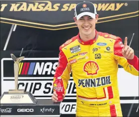  ?? ORLIN WAGNER — THE ASSOCIATED PRESS ?? Joey Logano celebrates winning Sunday’s NASCAR Cup Series race at Kansas Speedway.