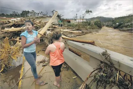  ?? Photograph­s by Carolyn Cole Los Angeles Times ?? UTUADO RESIDENTS struggle to recover after Hurricane Maria. Among the casualties are three elderly sisters killed in a landslide.