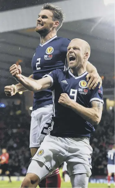  ??  ?? 0 Steven Naismith celebrates with Stephen O’donnell after the first goal at Hampden last night.