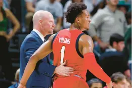  ?? AL GOLDIS/AP ?? Maryland coach Kevin Willard, left, talks with Jahmir Young during a game against Michigan State on Tuesday night in East Lansing, Michigan.