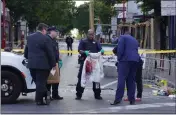  ?? MICHAEL PEREZ — THE ASSOCIATED PRESS ?? Philadelph­ia Police investigat­ors work the scene of a fatal overnight shooting on South Street in Philadelph­ia on Sunday.