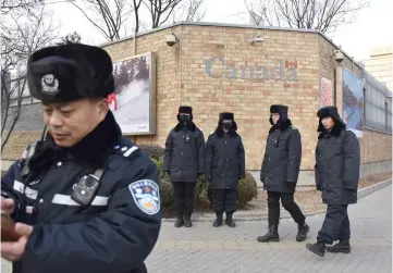  ??  ?? Chinese police officers patrol outside the Canadian embassy in Beijing. — AFP photo