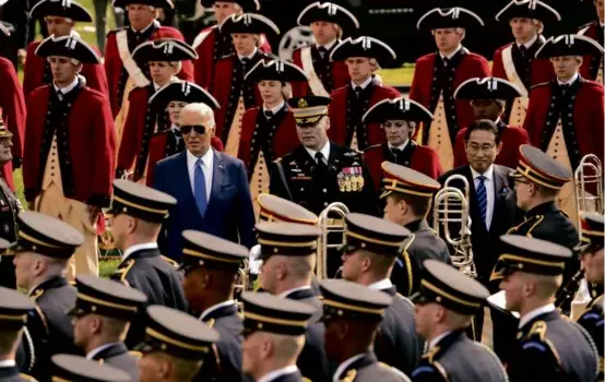  ?? SUSAN WALSH/ASSOCIATED PRESS ?? From center left, President Biden; Colonel David Rowland, commander of the 3rd US Infantry Regiment (The Old Guard); and Japanese Prime Minister Fumio Kishida reviewed the troops during an arrival ceremony at the White House Wednesday.