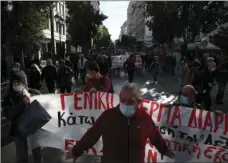  ?? AP PHOTO/THANASSIS STAVRAKIS ?? Protesters wearing face masks to curb the spread of COVID-19 take part in a rally during a 24-hour strike, on Thursday.